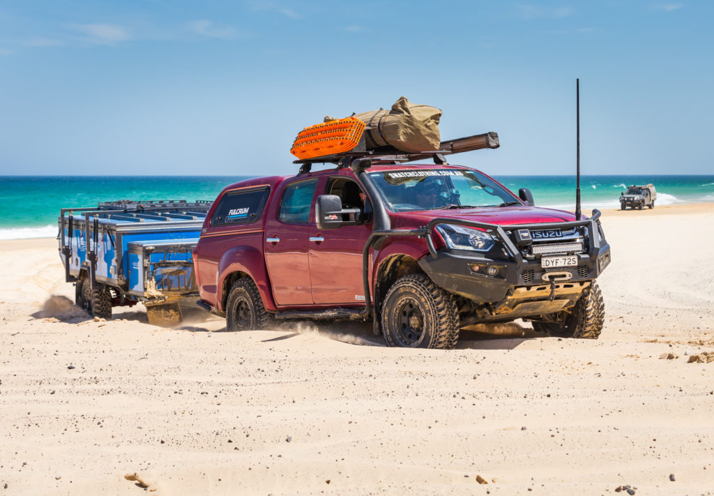 A 4WD and trailer driving over the beach